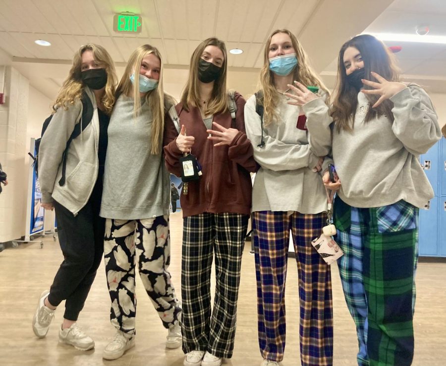 A group of students show off their plaid PJ pants. 
