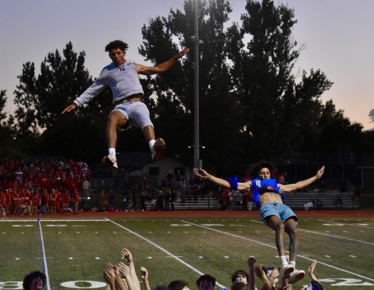 Jameson Love (24) and Christian Stein (24) being tossed in the air during the senior PowderPuff routine. 