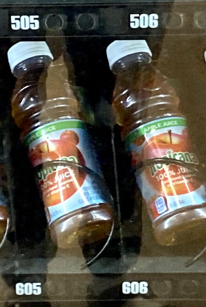 Two bottles of apple juice in the cafeteria vending machine
