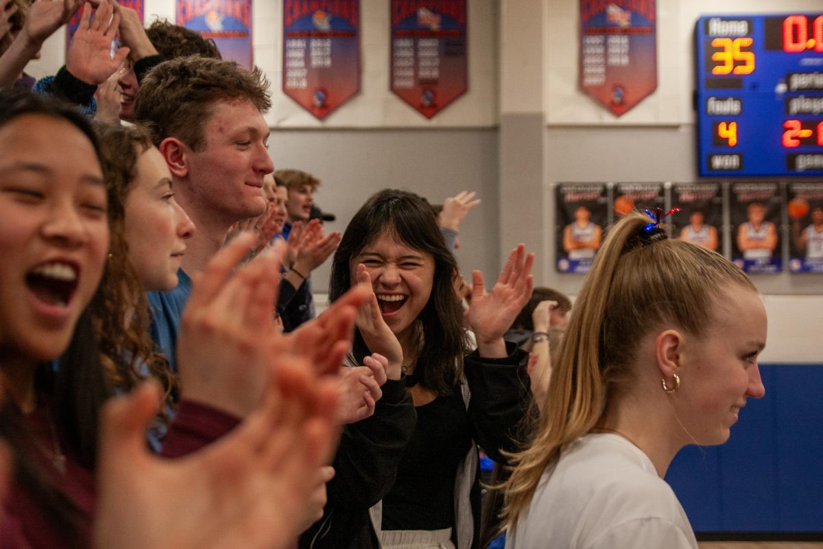 Students cheer on the Centaurus varsity men’s basketball team after they scored a three-point shot against Windsor highschool. 