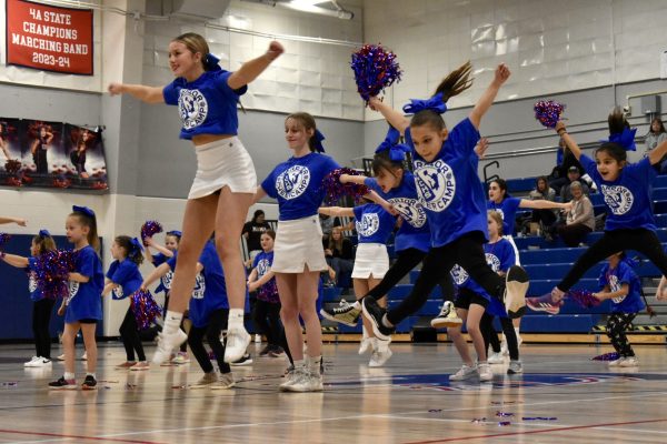 The entire goup doing a toe-touch jump during their halftime performance on 2/9.