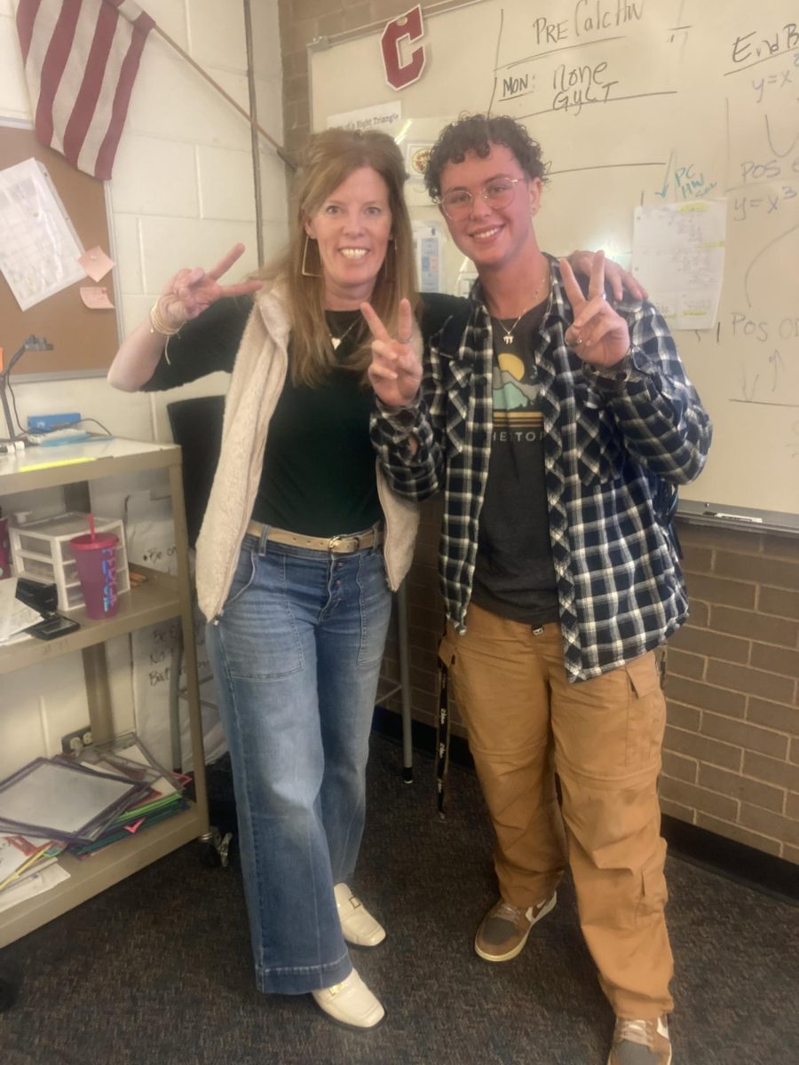Ms.+Ferguson+poses+with+Zeke+Webber+%2825%29%2C+a+student+in+her+first+period+pre-calc+class.+