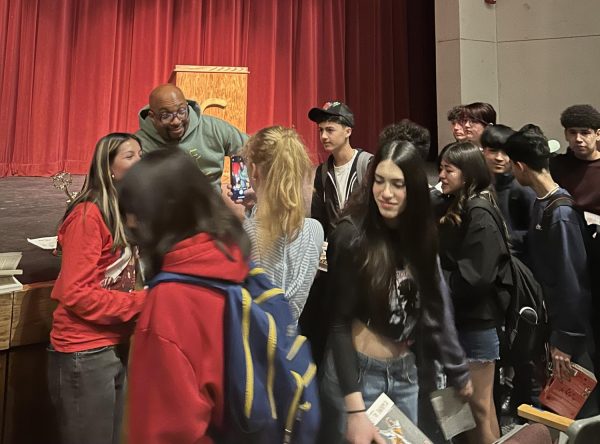 Kwame Alexander signs books following an inspiring talk about his story.